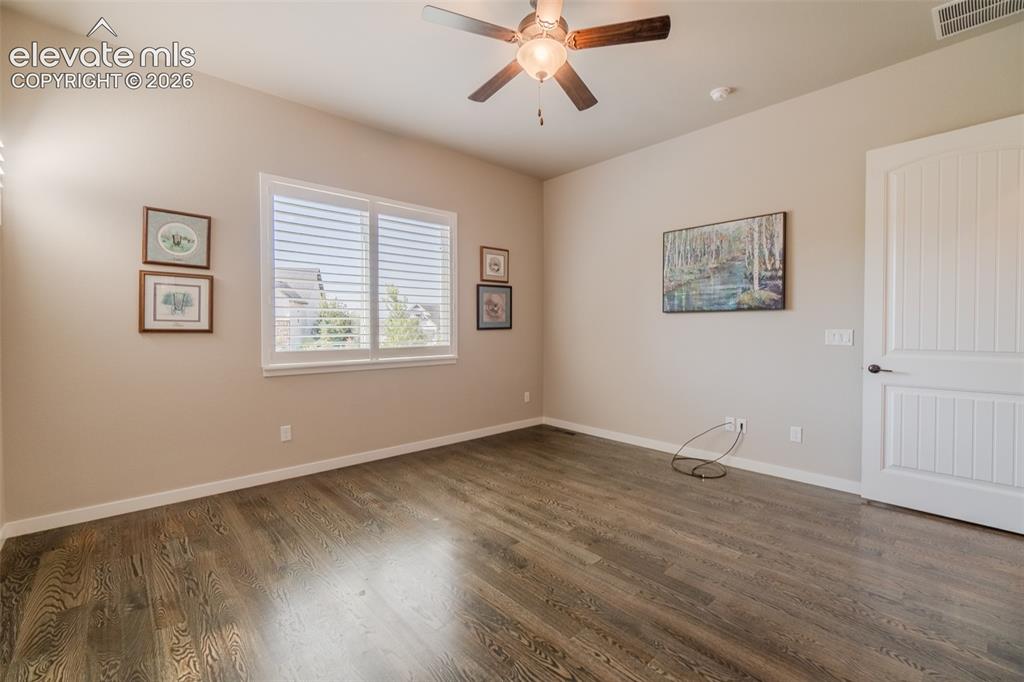 1061 Native Dancer Terrace Colorado Springs, CO 80921 - Photo 27 of 50 Spacious room featuring wood-finish flooring, a ceiling fan with integrated lighting, and a window with white blinds
