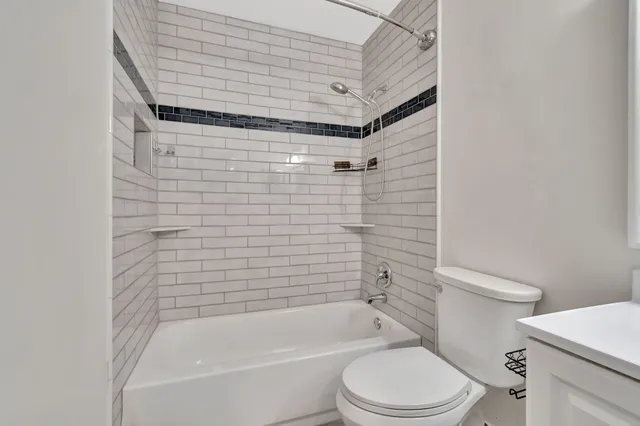 a bathroom with a toilet and a bathtub