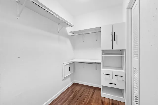 a view of walk in closet with empty racks