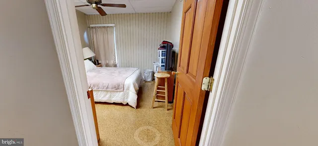 a bed room with a bed and a flat tv screen