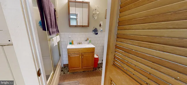 a bathroom with a sink a toilet and shower curtain