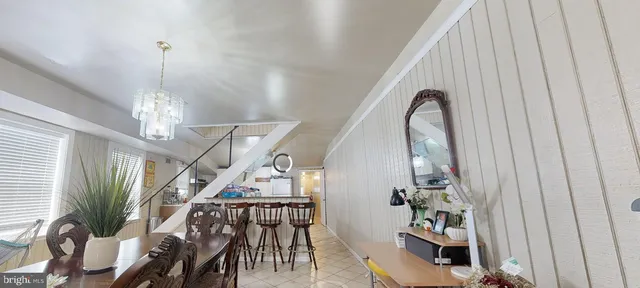 a kitchen with stainless steel appliances granite countertop a sink a stove and chairs