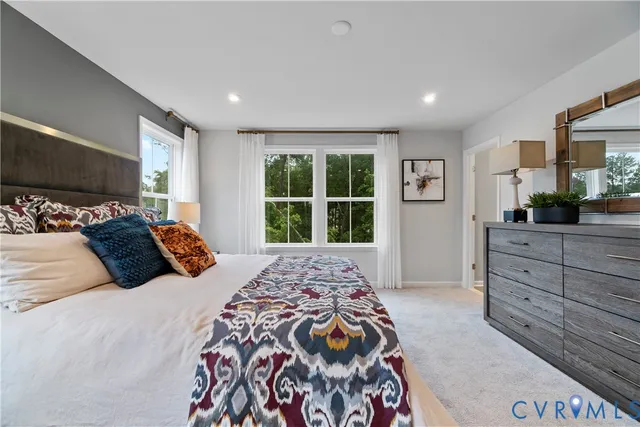 a bedroom with a large bed and a window