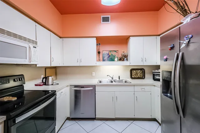 a kitchen with a sink a stove and cabinets