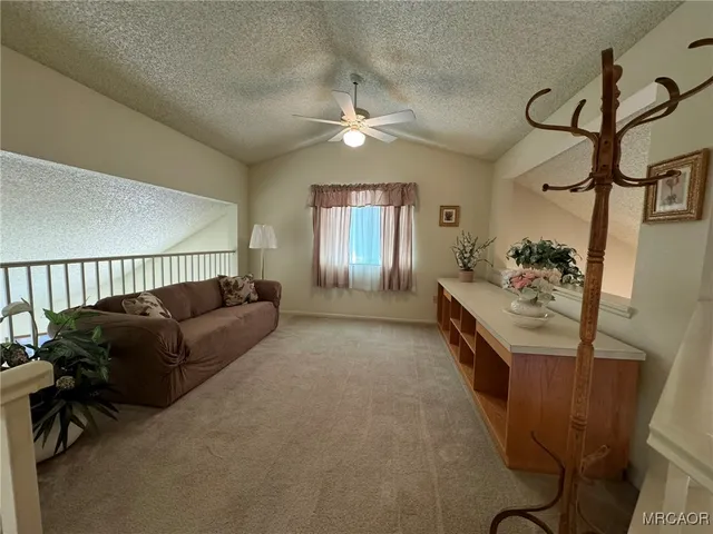 a view of a livingroom with furniture and staircase