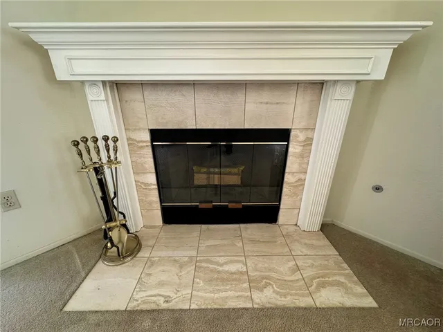 a living room with a fireplace and a painting on the wall