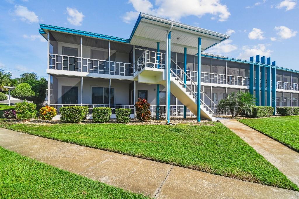 1600 West Lake Parker Drive, Unit B22 Lakeland, FL 33805 - Photo 1 of 26 a front view of a house with a yard