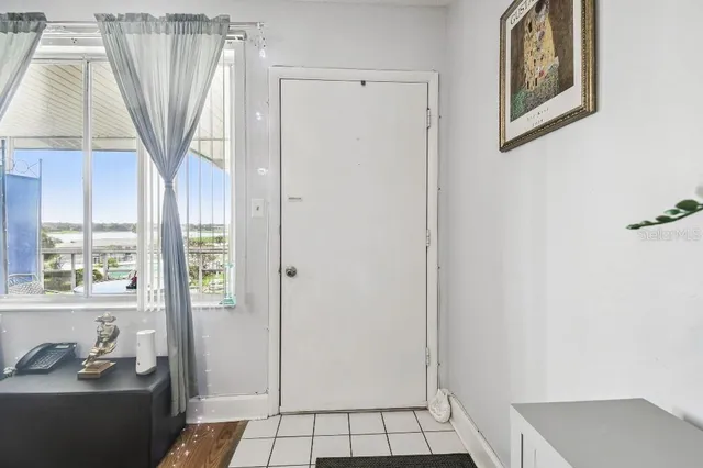 a view of a room that has a door and a window