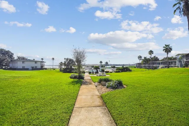 a view of yard with swimming pool and green space