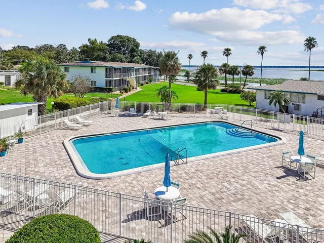 a swimming pool with outdoor seating and yard