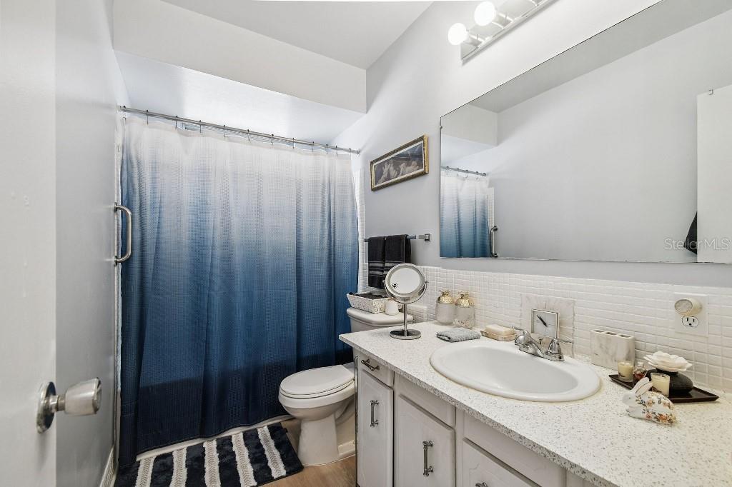 1600 West Lake Parker Drive, Unit B22 Lakeland, FL 33805 - Photo 8 of 26 a bathroom with a sink a toilet and shower