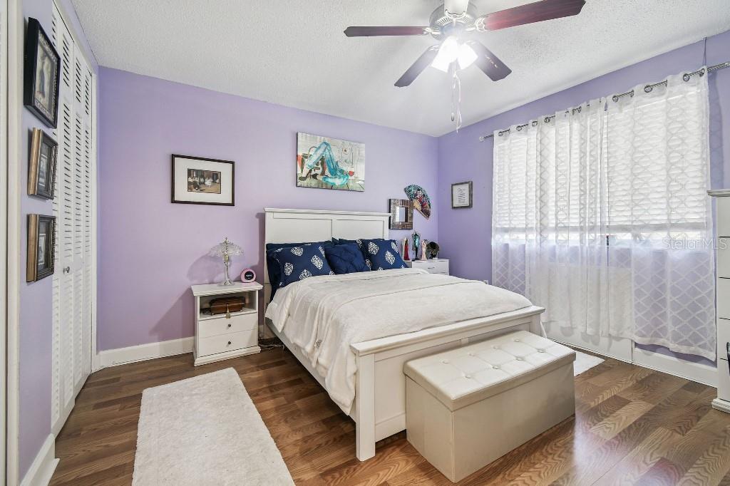 1600 West Lake Parker Drive, Unit B22 Lakeland, FL 33805 - Photo 9 of 26 a bedroom with a bed and a chandelier