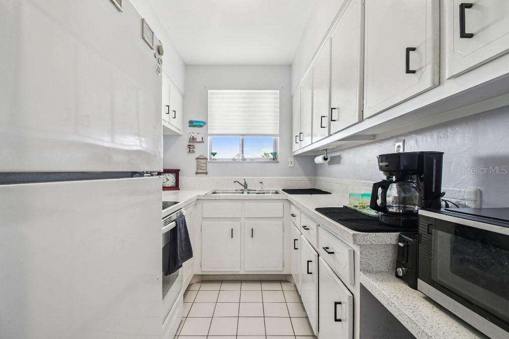1600 West Lake Parker Drive, Unit B22 Lakeland, FL 33805 - Photo 10 of 26 a kitchen with a sink stove and cabinets