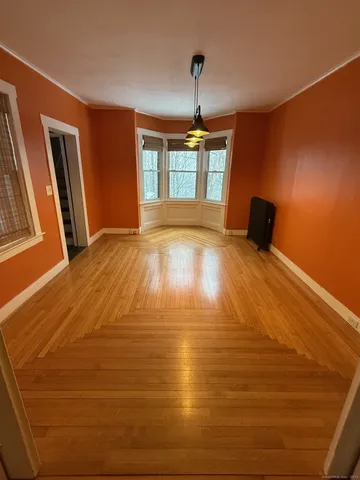a view of a room with wooden floor and staircase