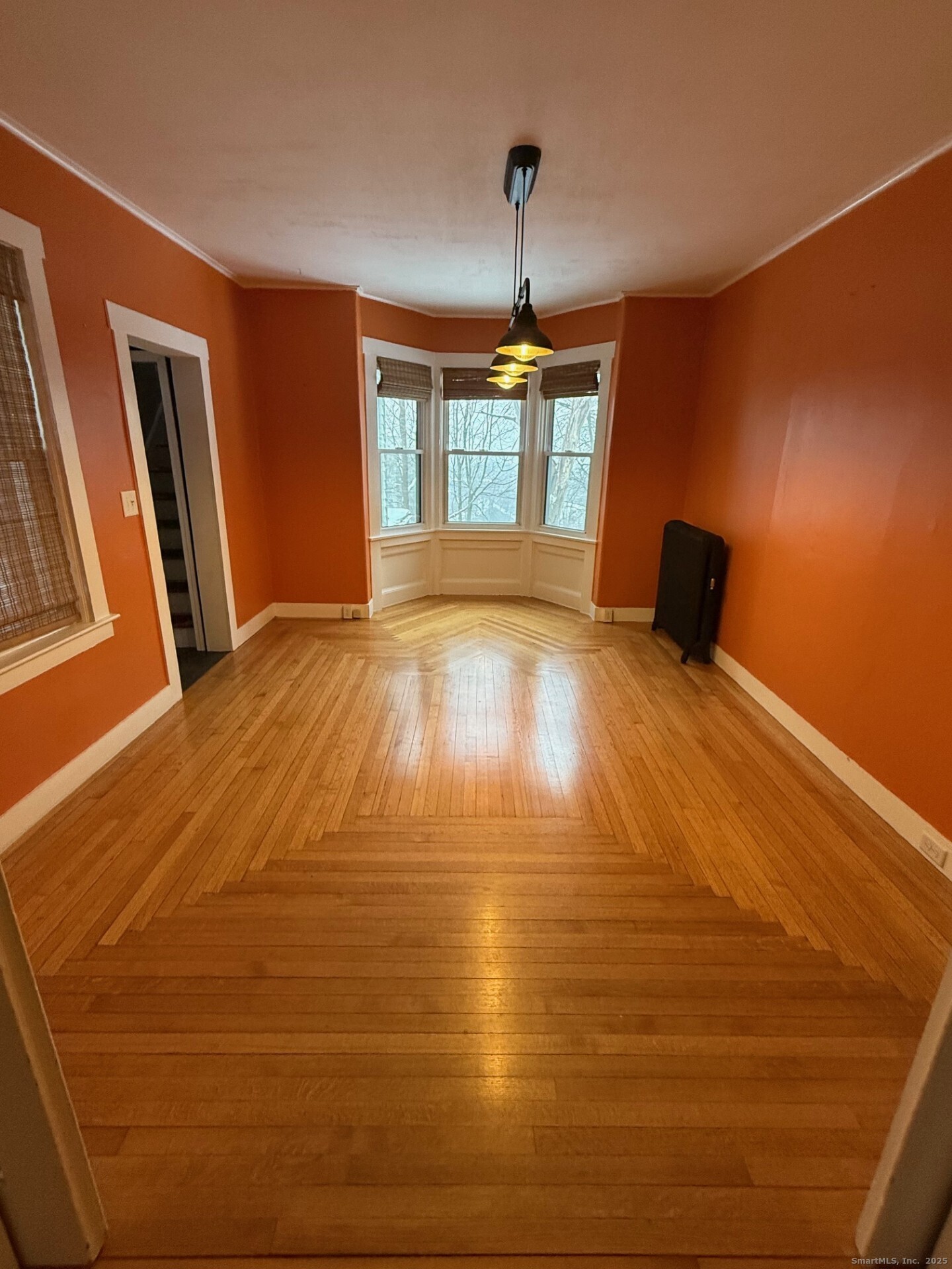 16 Wilkinson Street Putnam, CT 06260 - Photo 12 of 35 a view of an empty room with window and wooden floor