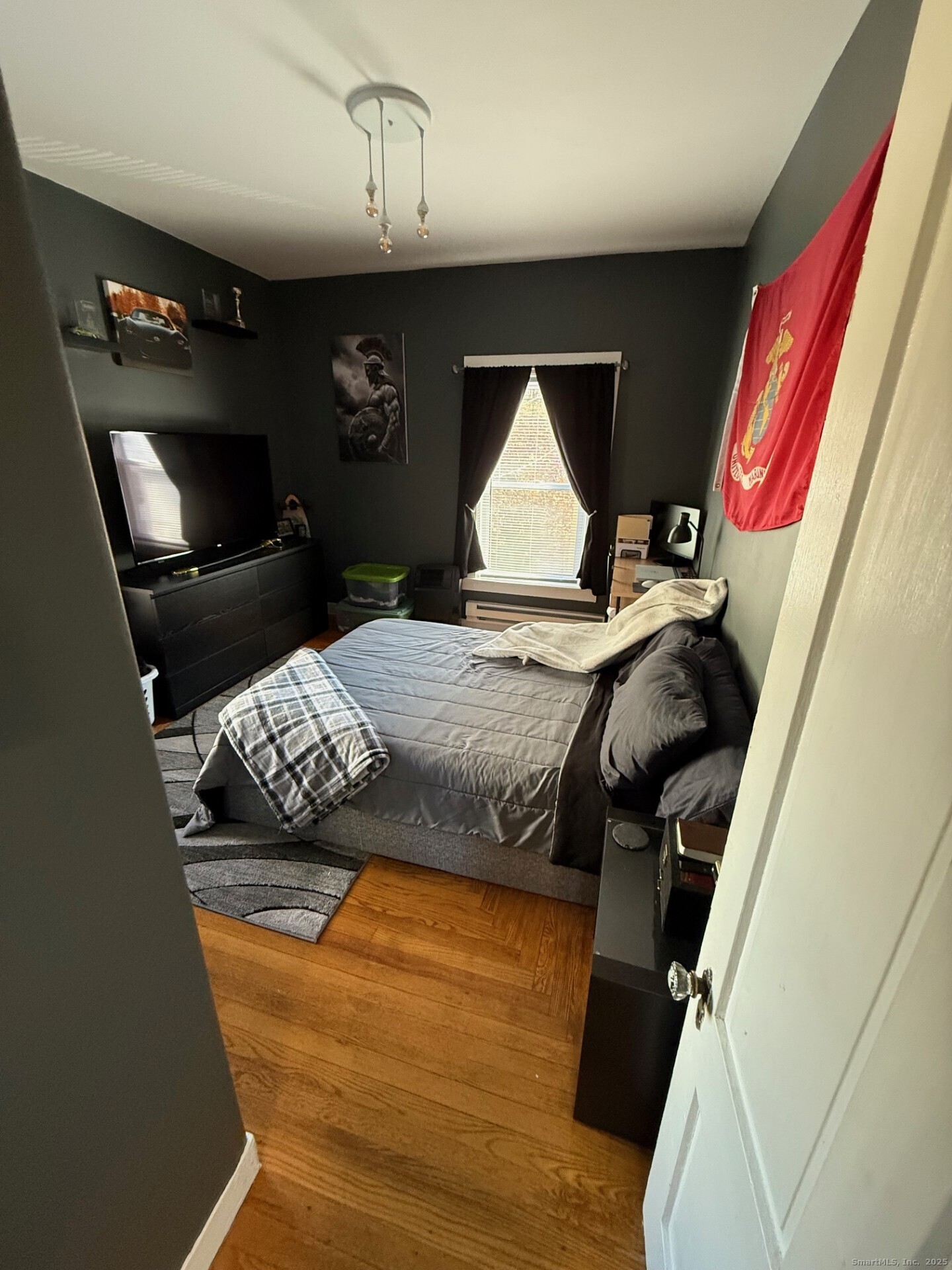 16 Wilkinson Street Putnam, CT 06260 - Photo 22 of 35 a bedroom with a bed and a chandelier