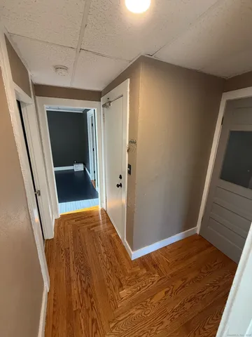 a white toilet sitting next to a white sink and vanity
