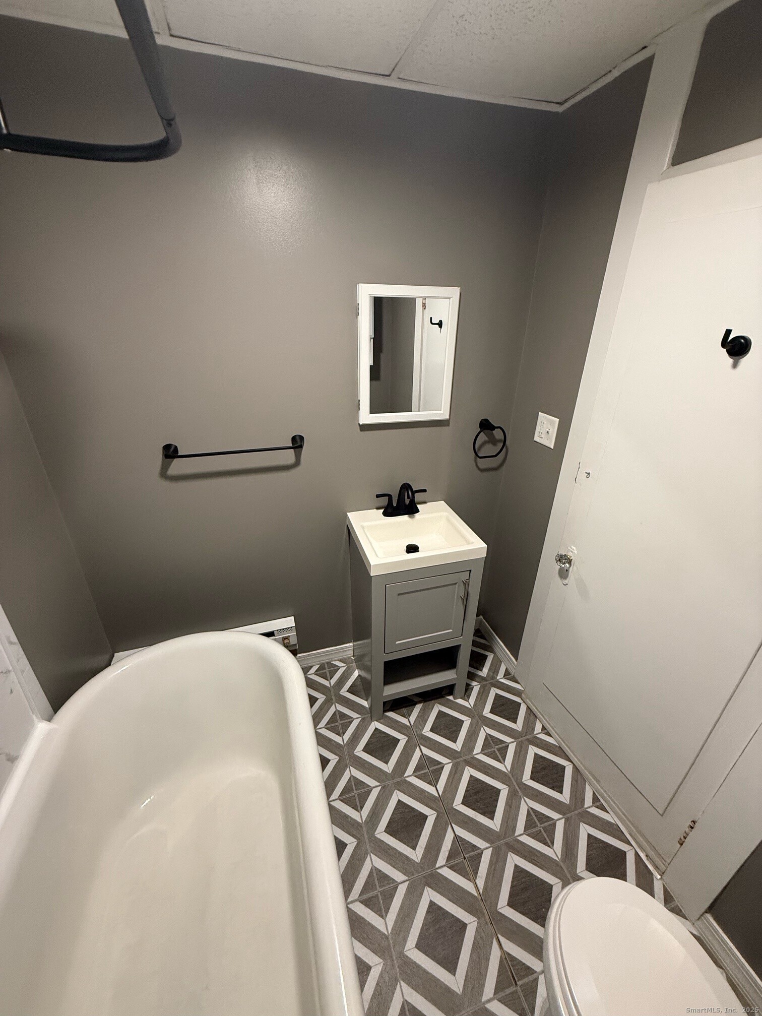 16 Wilkinson Street Putnam, CT 06260 - Photo 34 of 35 a white toilet sitting next to a white sink and vanity