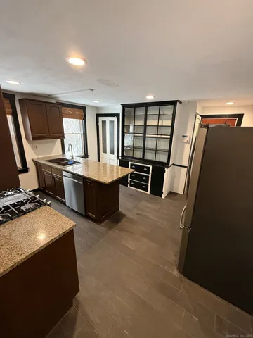 a living room with a couch and a stove top oven