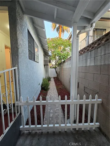 a view of a yard with wooden fence