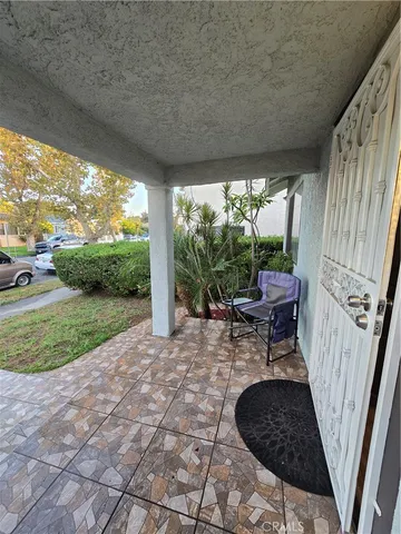a view of a porch with furniture and garden