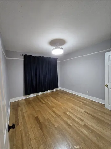 a big room with a bed and a chandelier