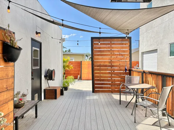 a view of a hallway with wooden floor and windows