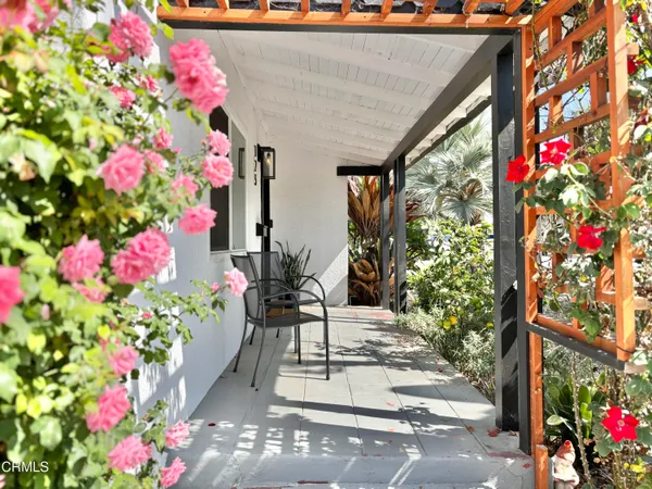 a large white kitchen with stainless steel appliances a stove a sink and a window