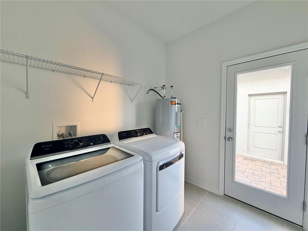 2348 Rider Rain Lane Apopka, FL 32703 - Photo 11 of 32 a utility room with dryer and washer
