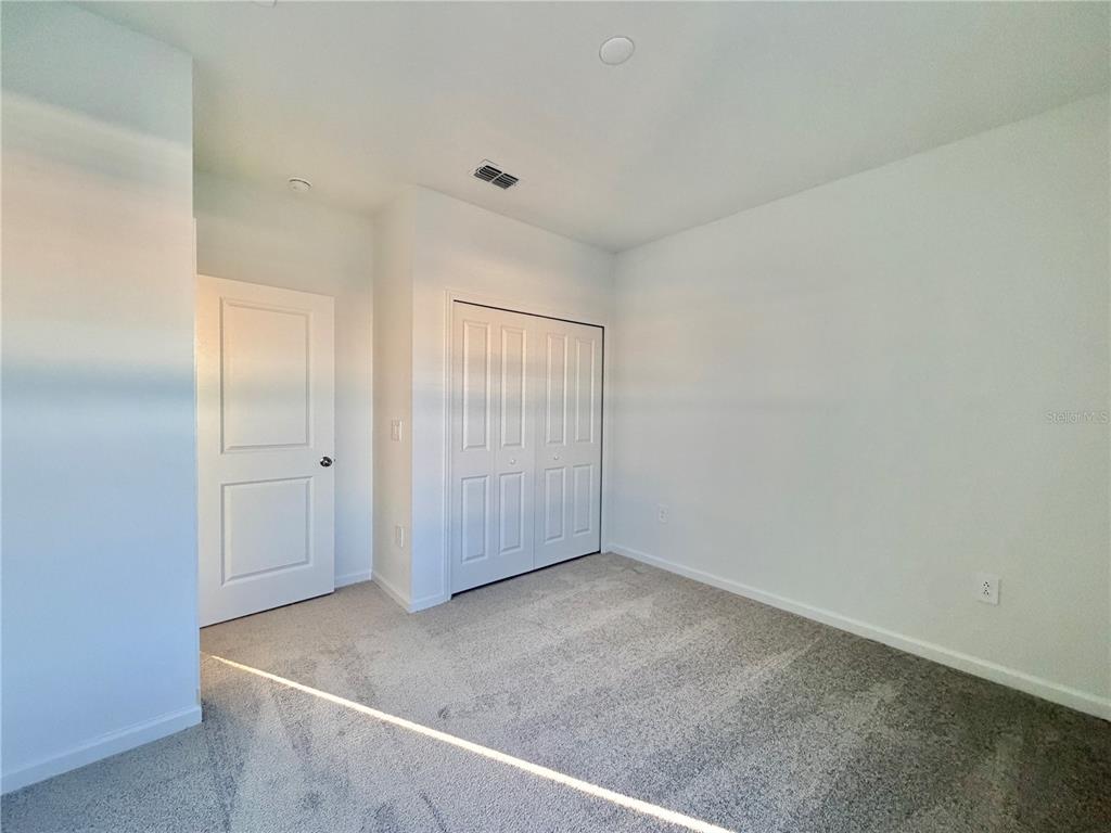 2348 Rider Rain Lane Apopka, FL 32703 - Photo 22 of 32 an empty room with windows