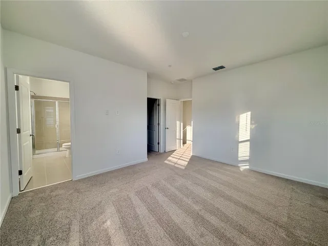 a en suite bathroom with a double vanity sink a mirror and a bathtub