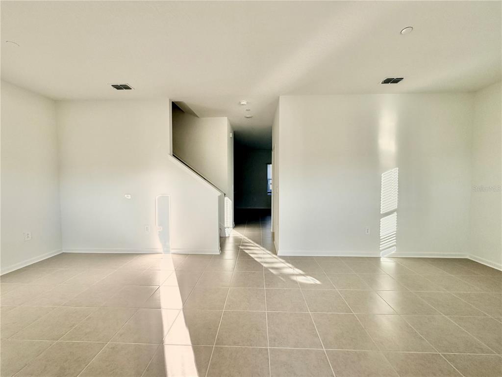 2348 Rider Rain Lane Apopka, FL 32703 - Photo 3 of 32 a view of an empty room with wooden floor