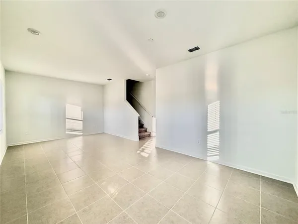 a bathroom with a granite countertop sink toilet a large mirror and a window
