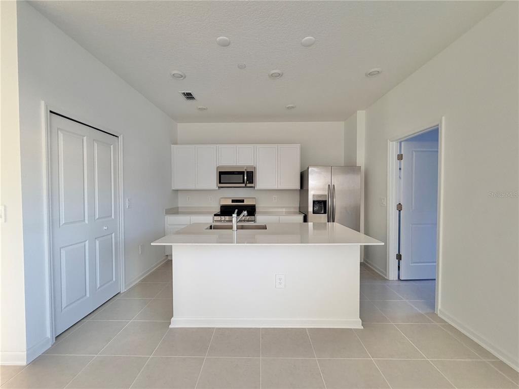2348 Rider Rain Lane Apopka, FL 32703 - Photo 10 of 32 a view of kitchen with stainless steel appliances a sink and a refrigerator