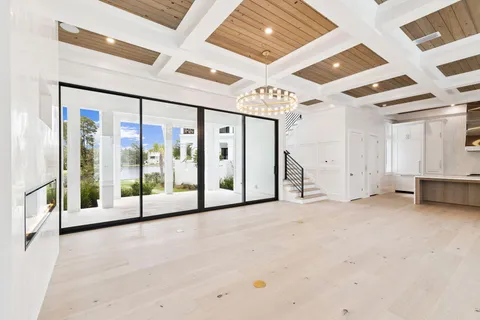 a view of an empty room with closet and windows