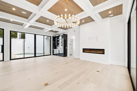 a view of an empty room with wooden floor and entryway