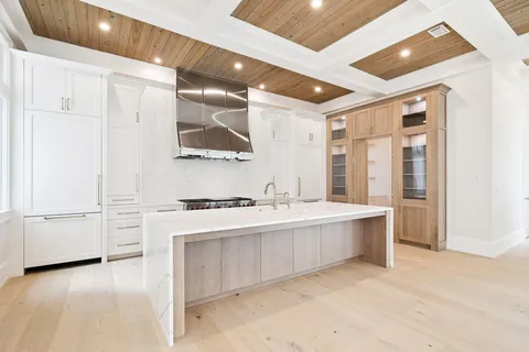 a view of an empty room with a fireplace and a window