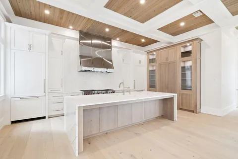 a kitchen with white cabinets and white appliances