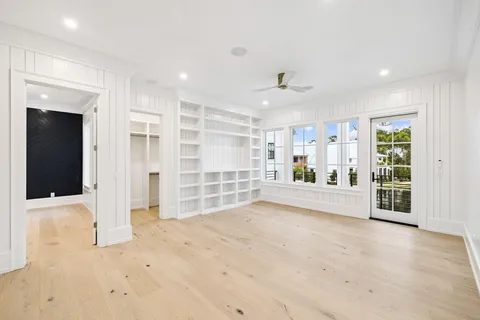 a view of staircase with white walls and white door