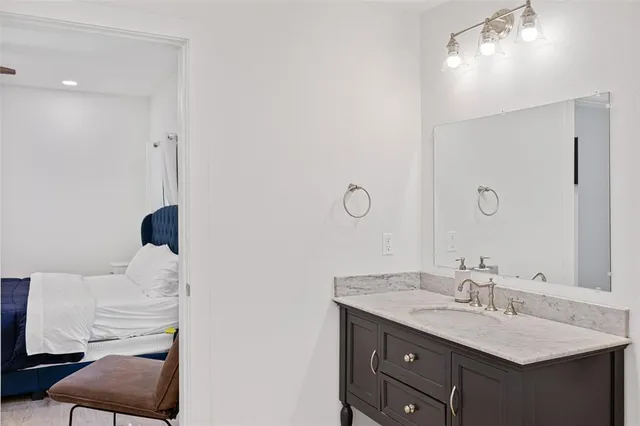 a bathroom with a double vanity sink toilet and a mirror