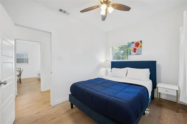 a bedroom with a bed and a chandelier