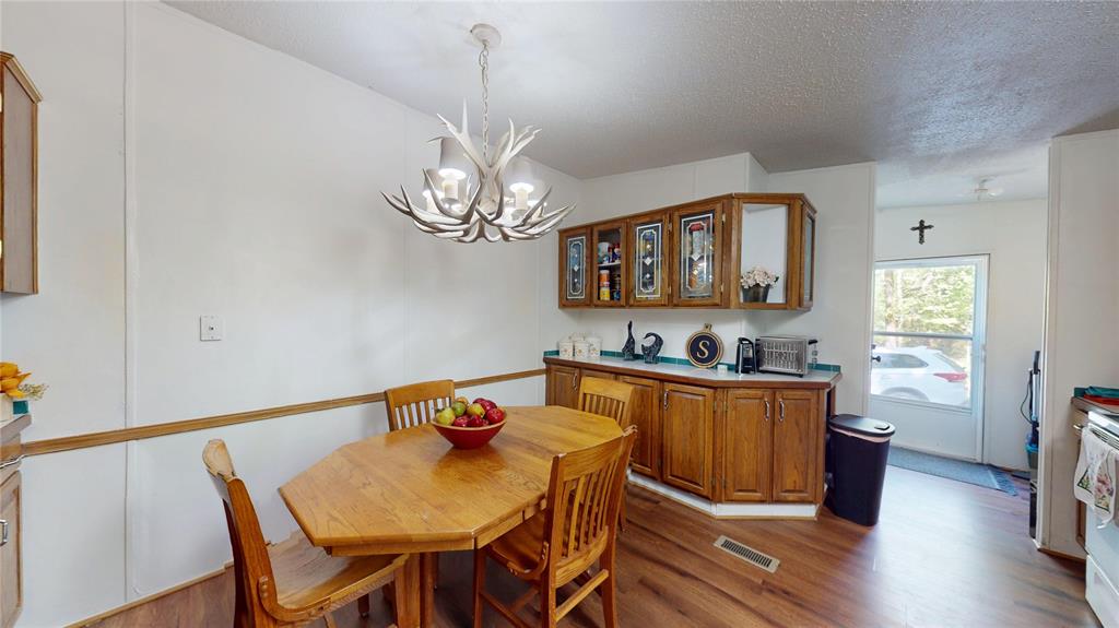 670 Arbin Culpepper Road Jonesboro, LA 71251 - Photo 12 of 17 a view of a dining room with furniture a chandelier and wooden floor