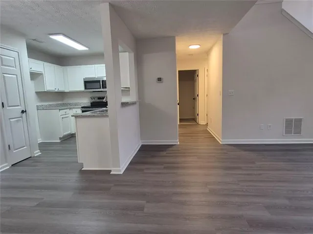 a view of kitchen with stainless steel appliances refrigerator microwave and stove