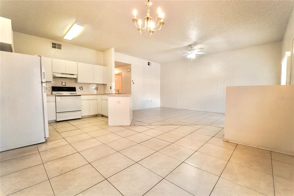 4150 Portillo Road, Unit 5 Spring Hill, FL 34608 - Photo 11 of 25 a kitchen with a stove a refrigerator and a cabinets