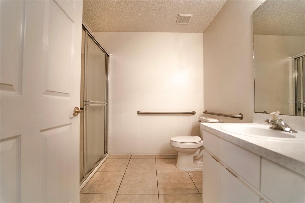4150 Portillo Road, Unit 5 Spring Hill, FL 34608 - Photo 15 of 25 a bathroom with a sink a toilet and shower
