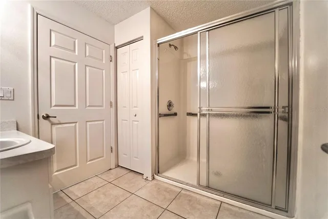 a bathroom with a glass shower door