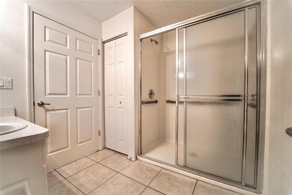 4150 Portillo Road, Unit 5 Spring Hill, FL 34608 - Photo 17 of 25 a bathroom with a glass shower door