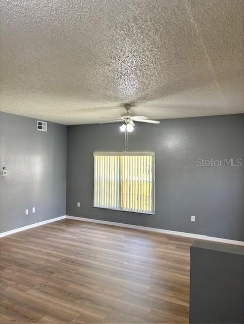 4150 Portillo Road, Unit 5 Spring Hill, FL 34608 - Photo 20 of 43 an empty room with wooden floor and windows
