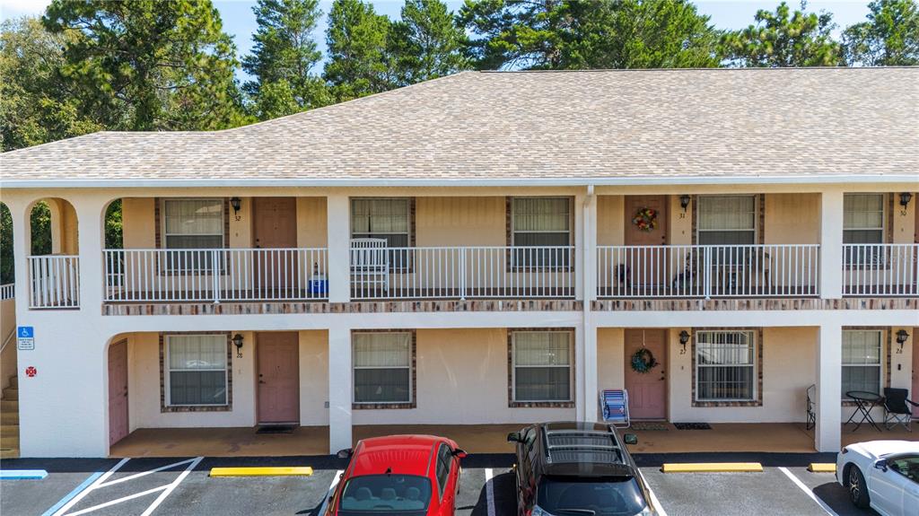 4150 Portillo Road, Unit 5 Spring Hill, FL 34608 - Photo 2 of 25 a front view of a residential apartment building with a yard