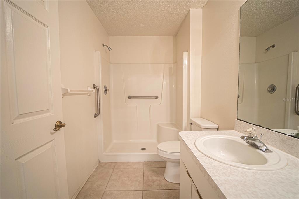 4150 Portillo Road, Unit 5 Spring Hill, FL 34608 - Photo 21 of 25 a bathroom with a sink a toilet and shower